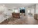 Modern living room features wood floors, sliding glass doors, and a blue accent wall at 4650 Ridgeley Ave # 103, North Las Vegas, NV 89084