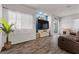 Bright living room with wood floors, a blue accent wall, and sliding doors to the backyard at 4650 Ridgeley Ave # 103, North Las Vegas, NV 89084