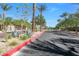 Scenic street with neatly landscaped medians, palm trees, and neighborhood views at 4650 Ridgeley Ave # 103, North Las Vegas, NV 89084