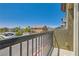 Balcony view showcasing the neighborhood with a black metal railing and textured exterior wall at 4720 Flower Moon Ave # 101, North Las Vegas, NV 89084