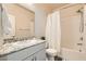 Bright bathroom featuring a single sink with granite countertops and a shower-tub combination with a curtain at 4720 Flower Moon Ave # 101, North Las Vegas, NV 89084