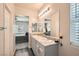 Well-lit bathroom with a double vanity, granite countertop, and an adjoining bedroom view at 4720 Flower Moon Ave # 101, North Las Vegas, NV 89084