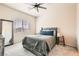 Cozy bedroom featuring a large bed, a window with blinds, and a ceiling fan at 4720 Flower Moon Ave # 101, North Las Vegas, NV 89084
