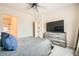 Bedroom featuring a gray comforter, a ceiling fan, and a TV on a gray wooden dresser at 4720 Flower Moon Ave # 101, North Las Vegas, NV 89084