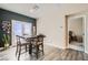 Dining area with a four-chair table, French doors, gray walls, and wood floors at 4720 Flower Moon Ave # 101, North Las Vegas, NV 89084