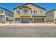 Stylish townhome showcasing a private balcony and attached garages, blending comfort and convenience at 4720 Flower Moon Ave # 101, North Las Vegas, NV 89084