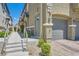 Close-up of a townhome exterior detailing the walkway, landscaping, and attached garage access at 4720 Flower Moon Ave # 101, North Las Vegas, NV 89084