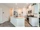 Well-lit kitchen featuring stainless steel appliances, granite countertops, and stylish white cabinets at 4720 Flower Moon Ave # 101, North Las Vegas, NV 89084