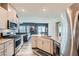 Open kitchen with granite countertops, stainless steel appliances, and a view to the living room at 4720 Flower Moon Ave # 101, North Las Vegas, NV 89084