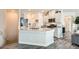Modern kitchen featuring a granite countertop island, stainless steel appliances, and sleek gray cabinets at 4720 Flower Moon Ave # 101, North Las Vegas, NV 89084
