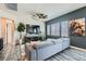 Comfortable living area showcasing gray sofa, modern ceiling fan, sleek floors, and a dark accent wall at 4720 Flower Moon Ave # 101, North Las Vegas, NV 89084