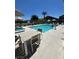 A community pool is surrounded by lounge chairs and umbrellas on a sunny day with clear blue skies at 4720 Flower Moon Ave # 101, North Las Vegas, NV 89084