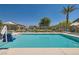 Community pool surrounded by mature landscaping offers a refreshing escape on sunny days at 4720 Flower Moon Ave # 101, North Las Vegas, NV 89084