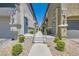 Well-maintained walkway leading to townhome entrances, enhanced by tasteful landscaping and exterior lighting at 4720 Flower Moon Ave # 101, North Las Vegas, NV 89084