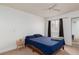Primary bedroom features a ceiling fan, closet and window with black-out curtains at 5114 S Jones Blvd # 202, Las Vegas, NV 89118