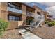 Building exterior showcasing private balconies, stairways, and desert landscaping at 5114 S Jones Blvd # 202, Las Vegas, NV 89118