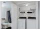 Laundry room features a washer, dryer, shelving, and a toilet/shower combo in a small closet at 5114 S Jones Blvd # 202, Las Vegas, NV 89118