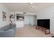 Open-concept living room with kitchen view, neutral paint, and lots of natural light at 5114 S Jones Blvd # 202, Las Vegas, NV 89118