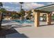 Community pool surrounded by desert landscaping and shady pergola at 5114 S Jones Blvd # 202, Las Vegas, NV 89118