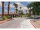 Well-maintained street view of the community with lush greenery, palm trees, and sidewalks at 5114 S Jones Blvd # 202, Las Vegas, NV 89118