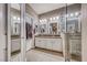 Bathroom featuring double sinks with granite counters and a large glass-enclosed shower at 52 Vallejo Verde St, Henderson, NV 89012