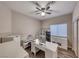 Comfortable office with ceiling fan, window, wood floor, desk, and furnishings at 52 Vallejo Verde St, Henderson, NV 89012