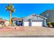 Charming single-story home with a well-manicured lawn, palm tree, and a two-car garage at 52 Vallejo Verde St, Henderson, NV 89012