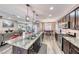 Open kitchen features large island with sink, stainless appliances, granite countertops, and plenty of cabinetry at 52 Vallejo Verde St, Henderson, NV 89012
