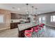 Gourmet kitchen features granite countertops, stainless appliances, a granite island, and pendant lighting at 52 Vallejo Verde St, Henderson, NV 89012