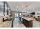 Well-lit kitchen flows into living room, featuring granite countertops, stainless appliances, and center island at 52 Vallejo Verde St, Henderson, NV 89012