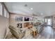 Cozy living room featuring lots of seating, several windows for natural light, and wood-look floors at 52 Vallejo Verde St, Henderson, NV 89012