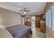 Comfortable bedroom features wood-look floors, shuttered windows, and barn door to the en suite bathroom at 52 Vallejo Verde St, Henderson, NV 89012