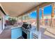 Inviting outdoor kitchen and patio area with built-in BBQ, bar, and relaxing lounge space at 52 Vallejo Verde St, Henderson, NV 89012