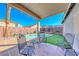 Relaxing pool patio area with comfortable seating, a putting green and lush landscaping at 52 Vallejo Verde St, Henderson, NV 89012