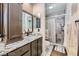 Bathroom featuring a granite vanity and shower with updated finishes at 5202 Willis St, North Las Vegas, NV 89031