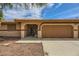 Traditional home featuring a two-car garage and secure gated entry at 5202 Willis St, North Las Vegas, NV 89031