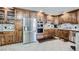 Spacious kitchen featuring updated stainless steel appliances, custom cabinetry, and tile floors at 5202 Willis St, North Las Vegas, NV 89031