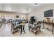 Open-concept living area with tile flooring, comfortable seating, and plenty of natural light at 5202 Willis St, North Las Vegas, NV 89031