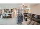 Open-concept living space with kitchen, dining area, and comfortable seating, featuring tile floors at 5202 Willis St, North Las Vegas, NV 89031