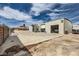 Large shop with open doors, concrete parking area and a few sheds along the side of the home at 5202 Willis St, North Las Vegas, NV 89031