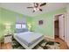 Comfortable bedroom features neutral walls, a ceiling fan and light-colored hardwood floors at 5576 W Rochelle Ave # 27C, Las Vegas, NV 89103