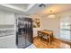 Charming eat-in kitchen with stainless steel refrigerator and granite countertops at 5576 W Rochelle Ave # 27C, Las Vegas, NV 89103