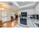 Updated kitchen features granite counters, white cabinets, and stainless steel appliances at 5576 W Rochelle Ave # 27C, Las Vegas, NV 89103