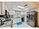 Modern kitchen with granite countertops, white cabinets, and stainless steel appliances at 5576 W Rochelle Ave # 27C, Las Vegas, NV 89103