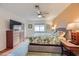 Comfortable bedroom features neutral walls, a ceiling fan and light-colored hardwood floors at 5576 W Rochelle Ave # 27C, Las Vegas, NV 89103