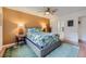 A bright bedroom featuring a ceiling fan and an ensuite bath at 5576 W Rochelle Ave # 27C, Las Vegas, NV 89103