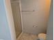 Simple bathroom with glass-enclosed shower stall, tiled floors, and a white toilet at 5655 E Sahara Ave # 2020, Las Vegas, NV 89142