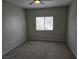 A cozy bedroom featuring neutral walls, carpet, a ceiling fan, and a window providing natural light at 5655 E Sahara Ave # 2020, Las Vegas, NV 89142