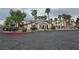 Community center exterior surrounded by palm trees and greenery at 5655 E Sahara Ave # 2020, Las Vegas, NV 89142
