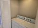 Laundry room with side-by-side washer and dryer and a louvered door at 5655 E Sahara Ave # 2020, Las Vegas, NV 89142
